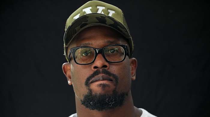 Bills pass rusher Von Miller looks on while speaking with reporters at a press conference.